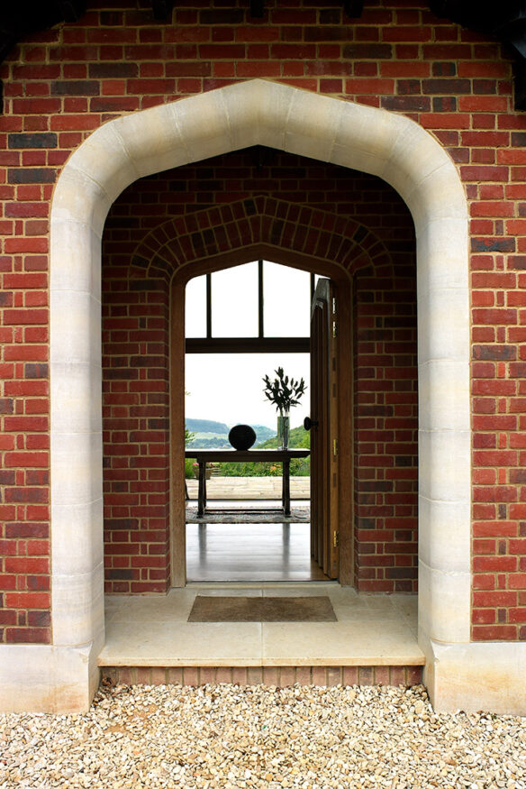 arch entrance hall leading through to hall with view through the building to countryside