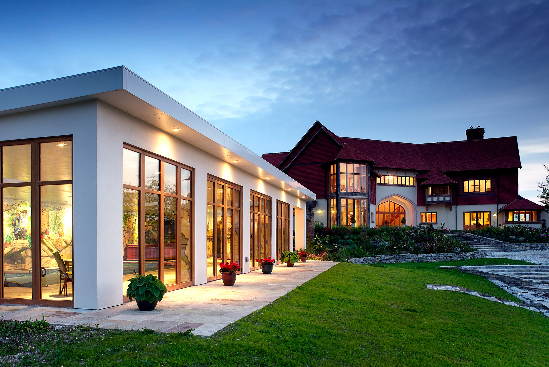 magnificent lime kiln house with red roof and large indoor pool at dusk