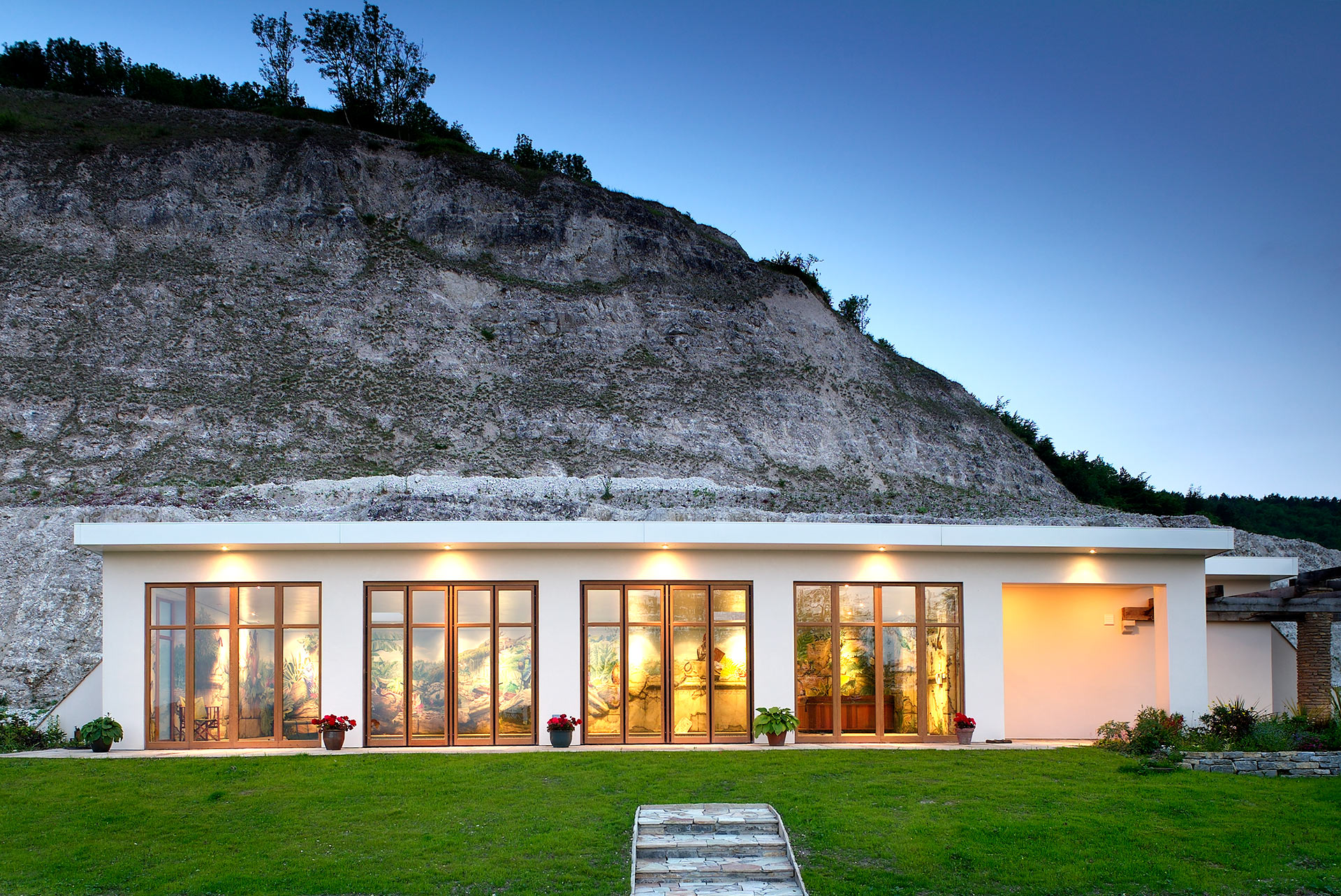 exterior of indoor pool room in chalk quarry at dusk