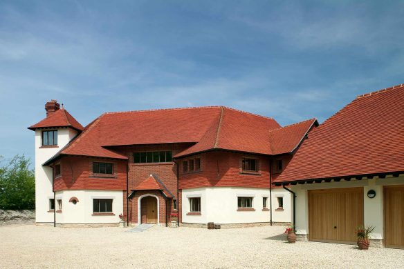 rear entrance to grand house with red tiles in daylight