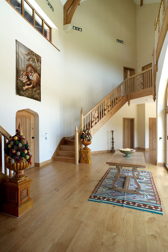 interior of entrance way with grand wooded dog legged staircase
