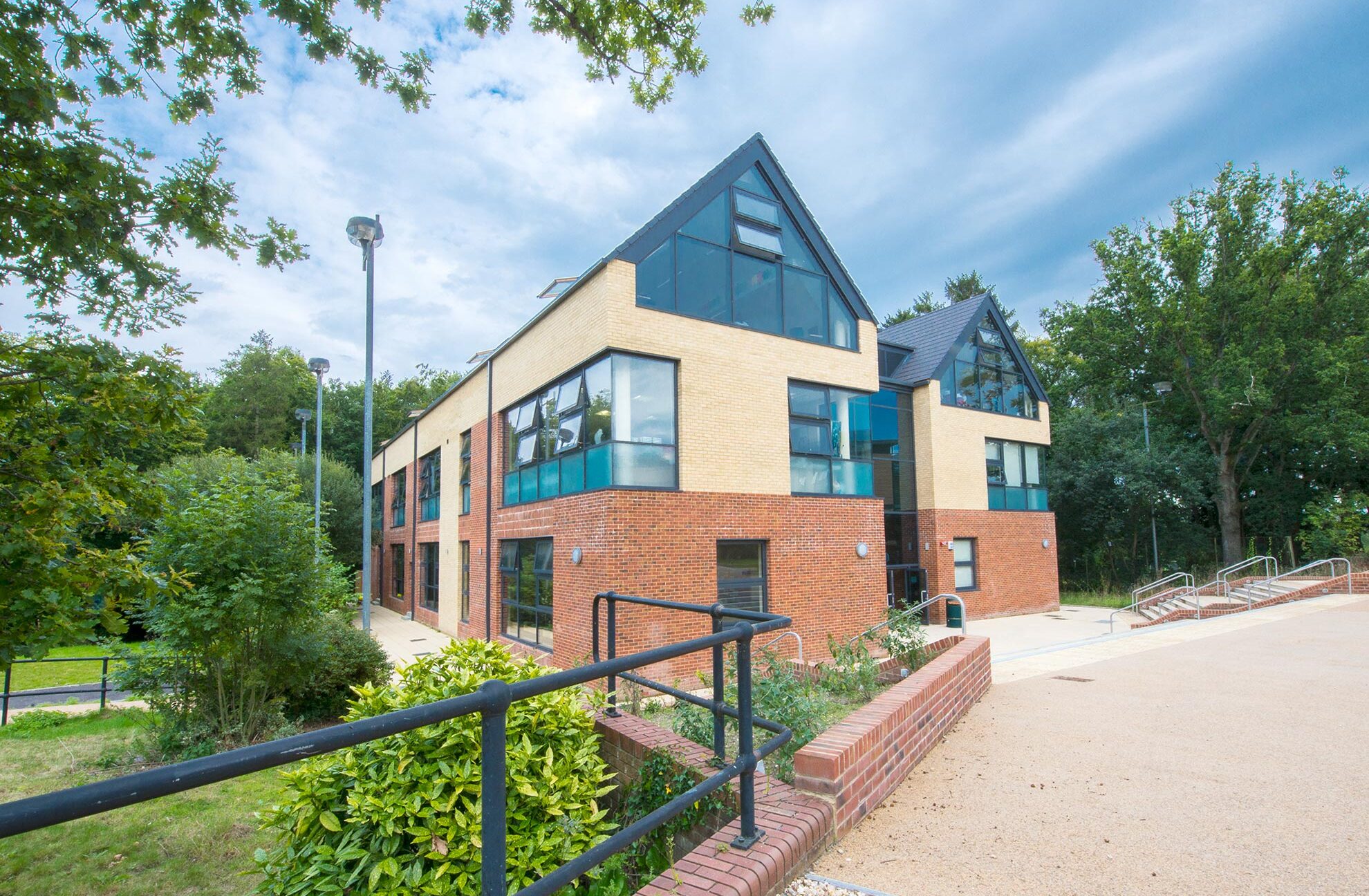 external view from approach of red brick school with large windows