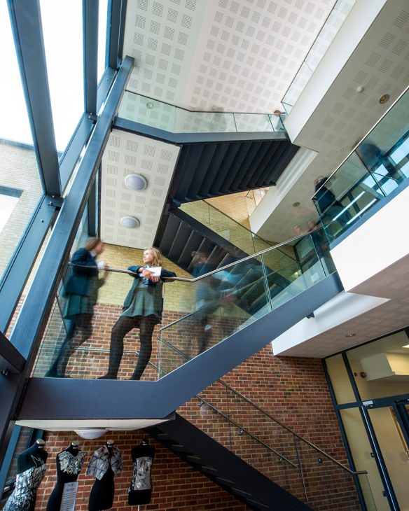 interior staircase spanning two floors with glass railing