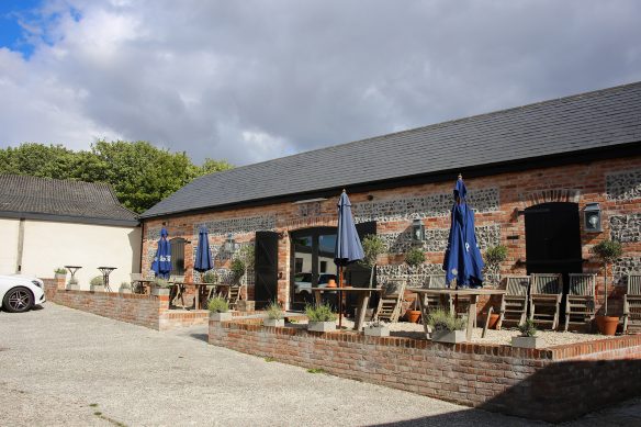 front view of finished red brick building with seating after in front