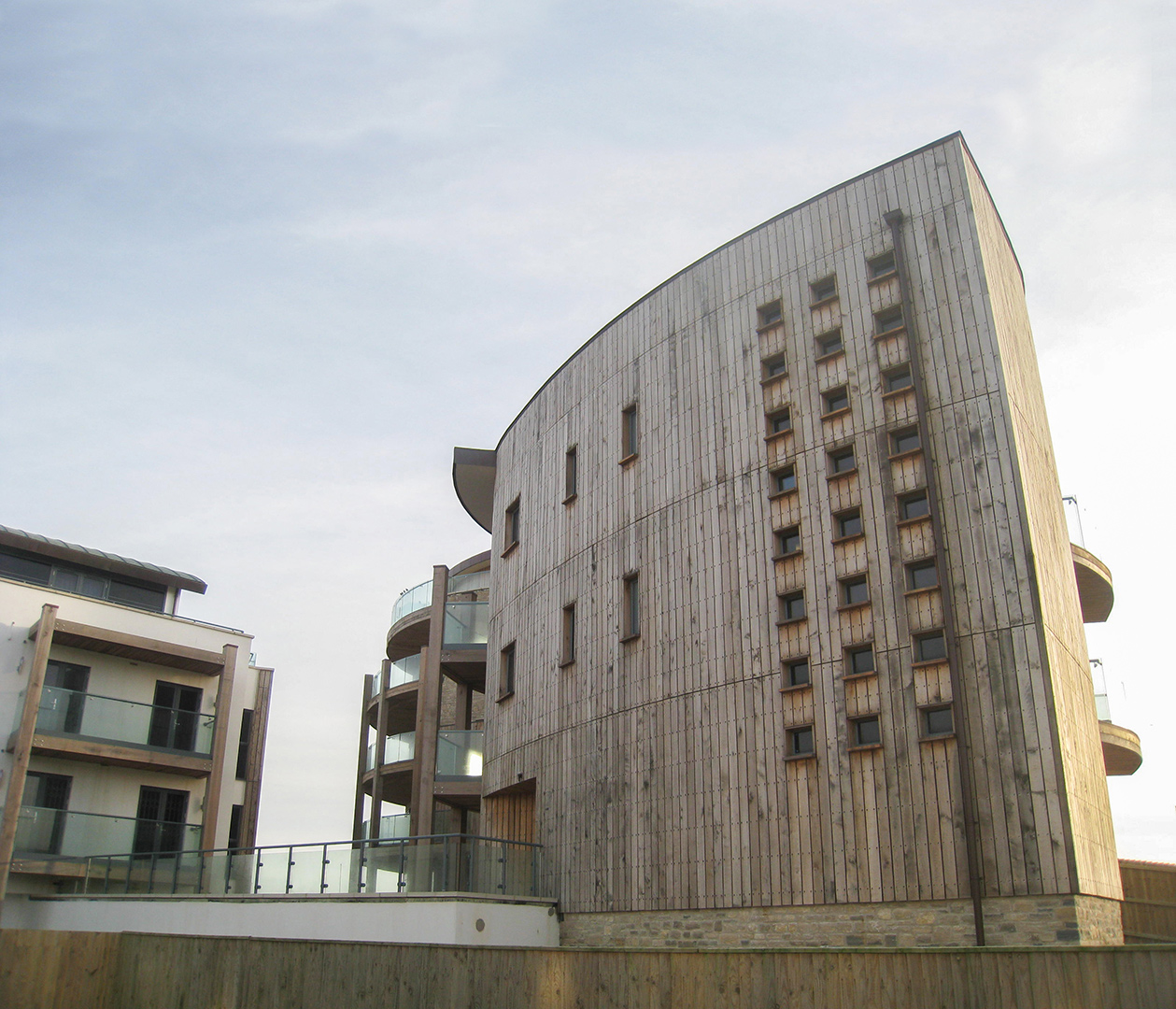 rear view of west bay apartments with wooden cladding on building