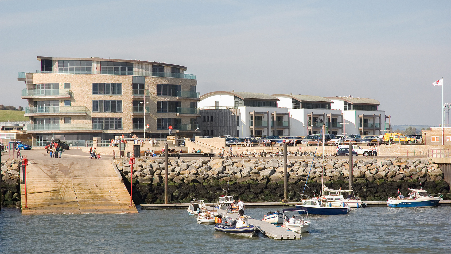 view of west bay apartments from the sea with boats in front