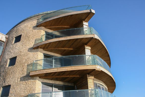 view of front of stone building with large glass balconies