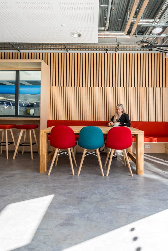 multicoloured seating area in cafe overlooking a swimming pool