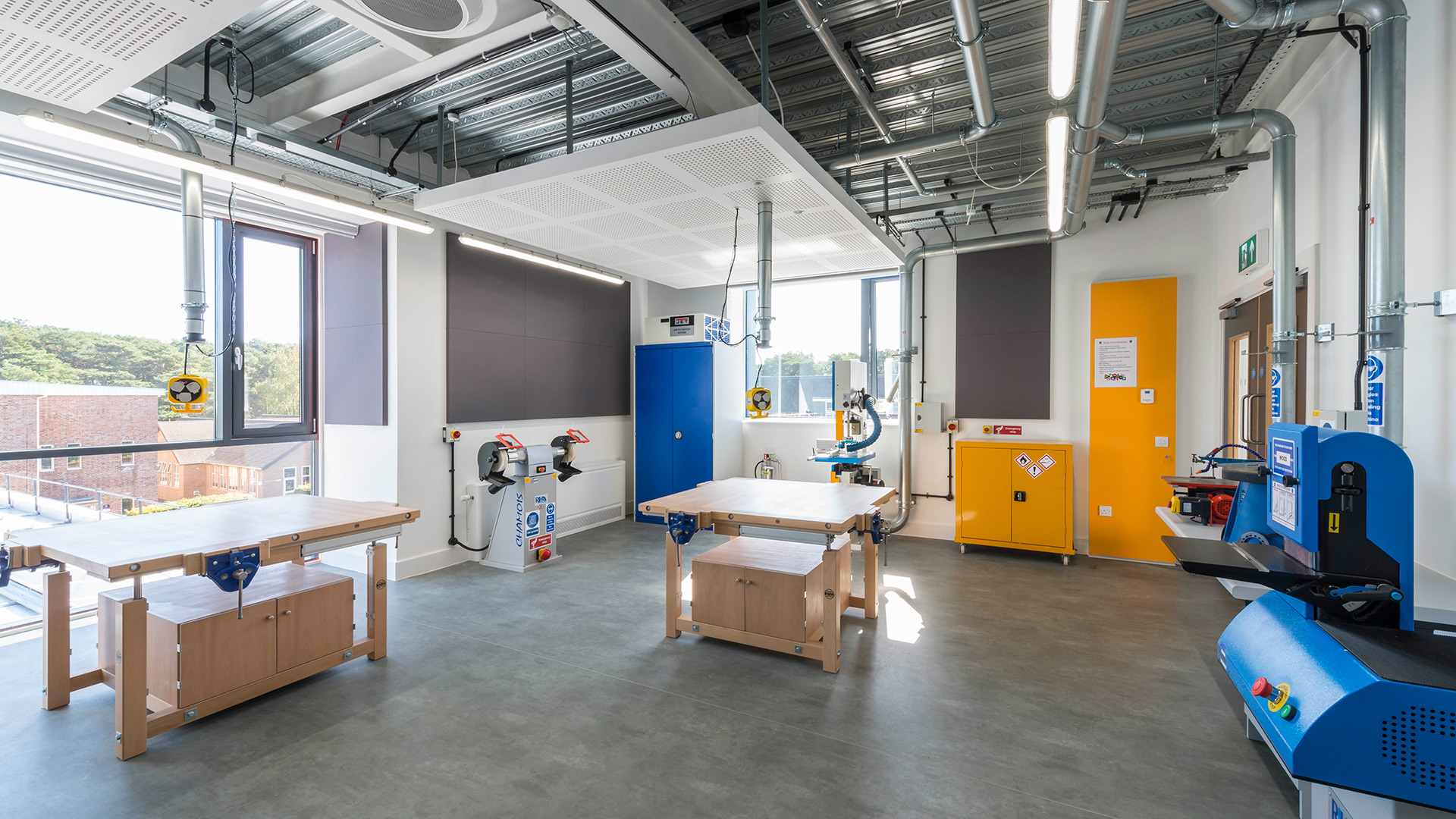 interior workshop classroom with work benches and exposed pipework