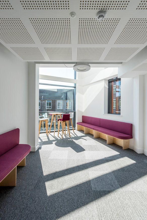 interior first floor hallway with pink seating and large windows