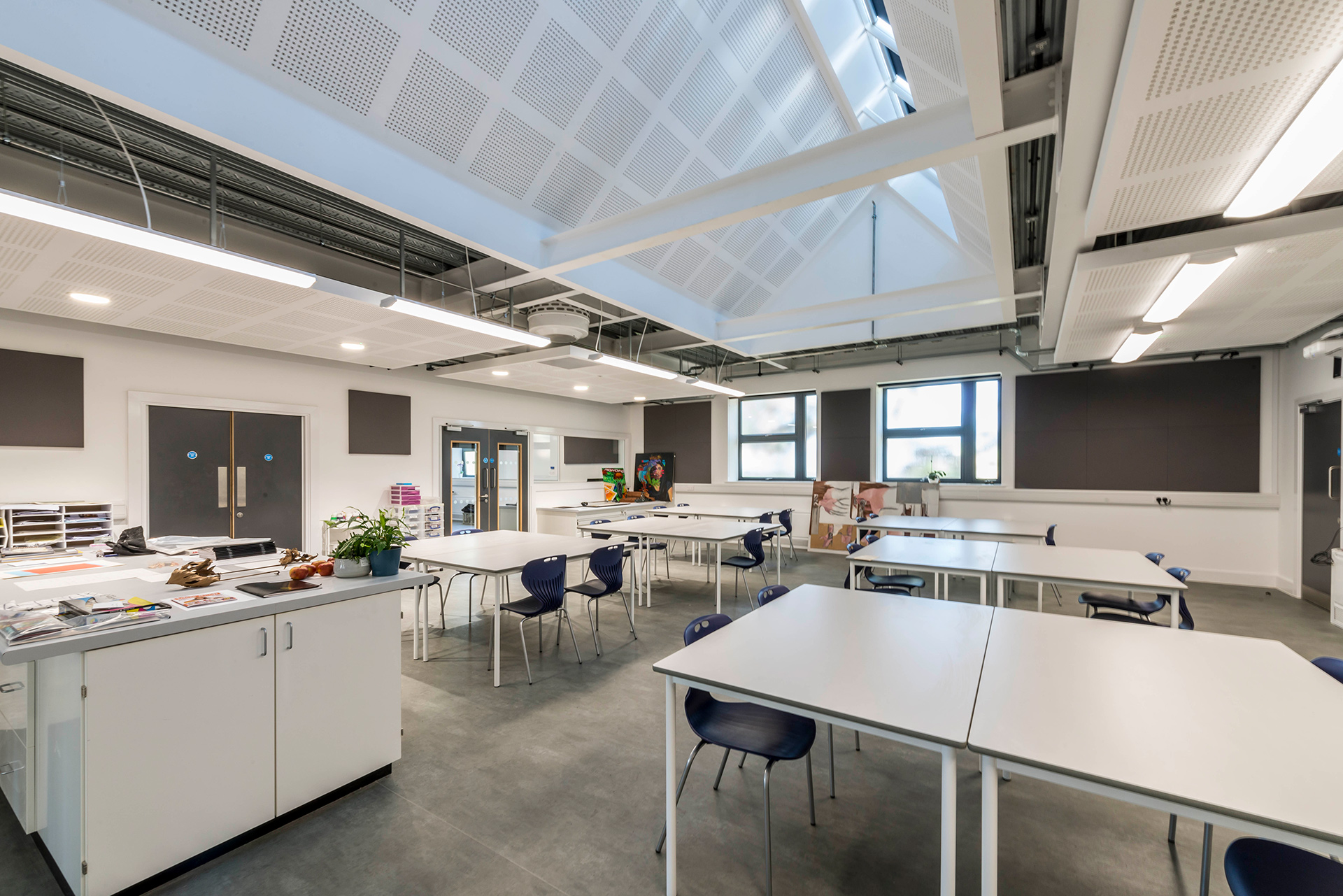 Interior of science room in school with double height vaulted ceiling and exposed beams