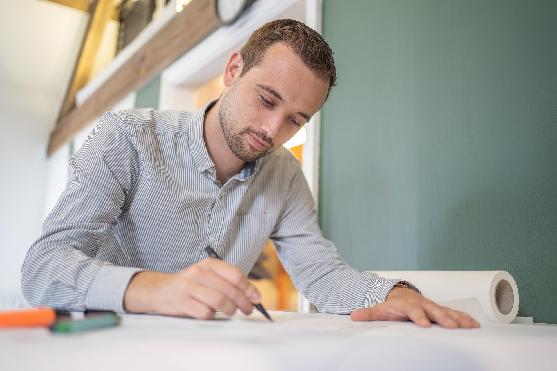 man sketching on table