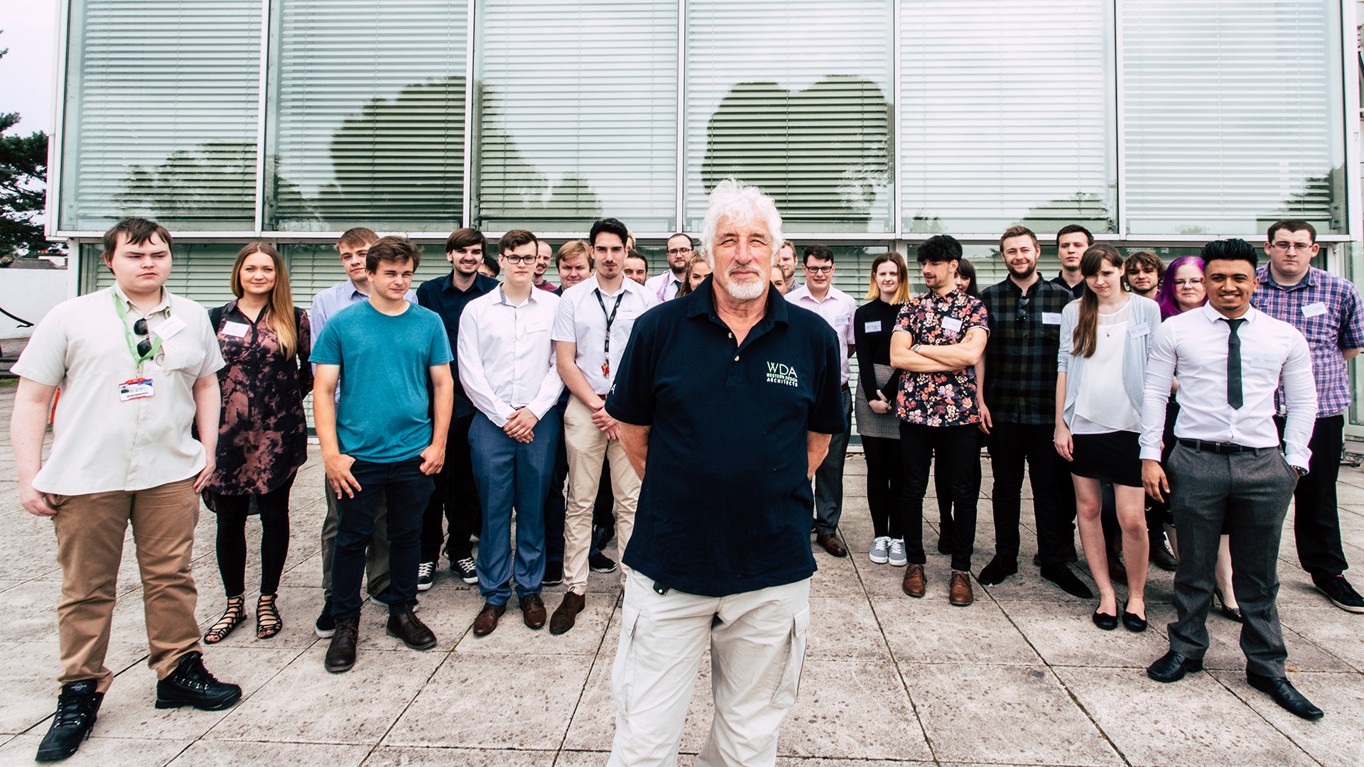 phil Easton, director, with a group of people behind him smiling