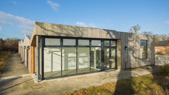 external rear view of building with wood cladding and large windows