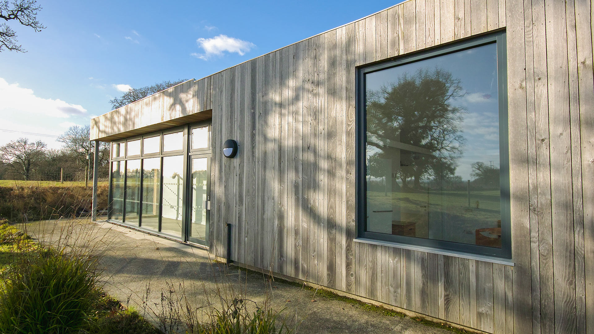 external side view of care centre with wood cladding and large windows