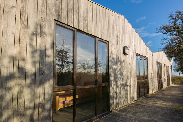 external side view of care centre with wood cladding and large windows