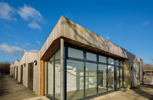 external rear view of building with wood cladding and large windows