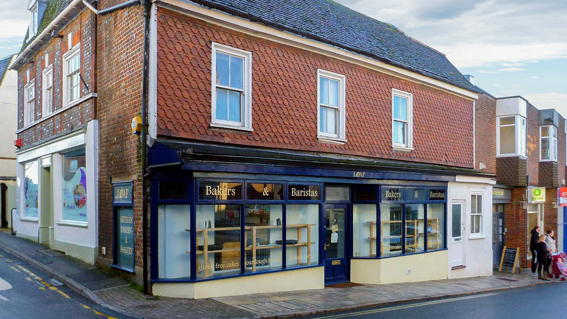 front and side view of building with bakery on ground floor