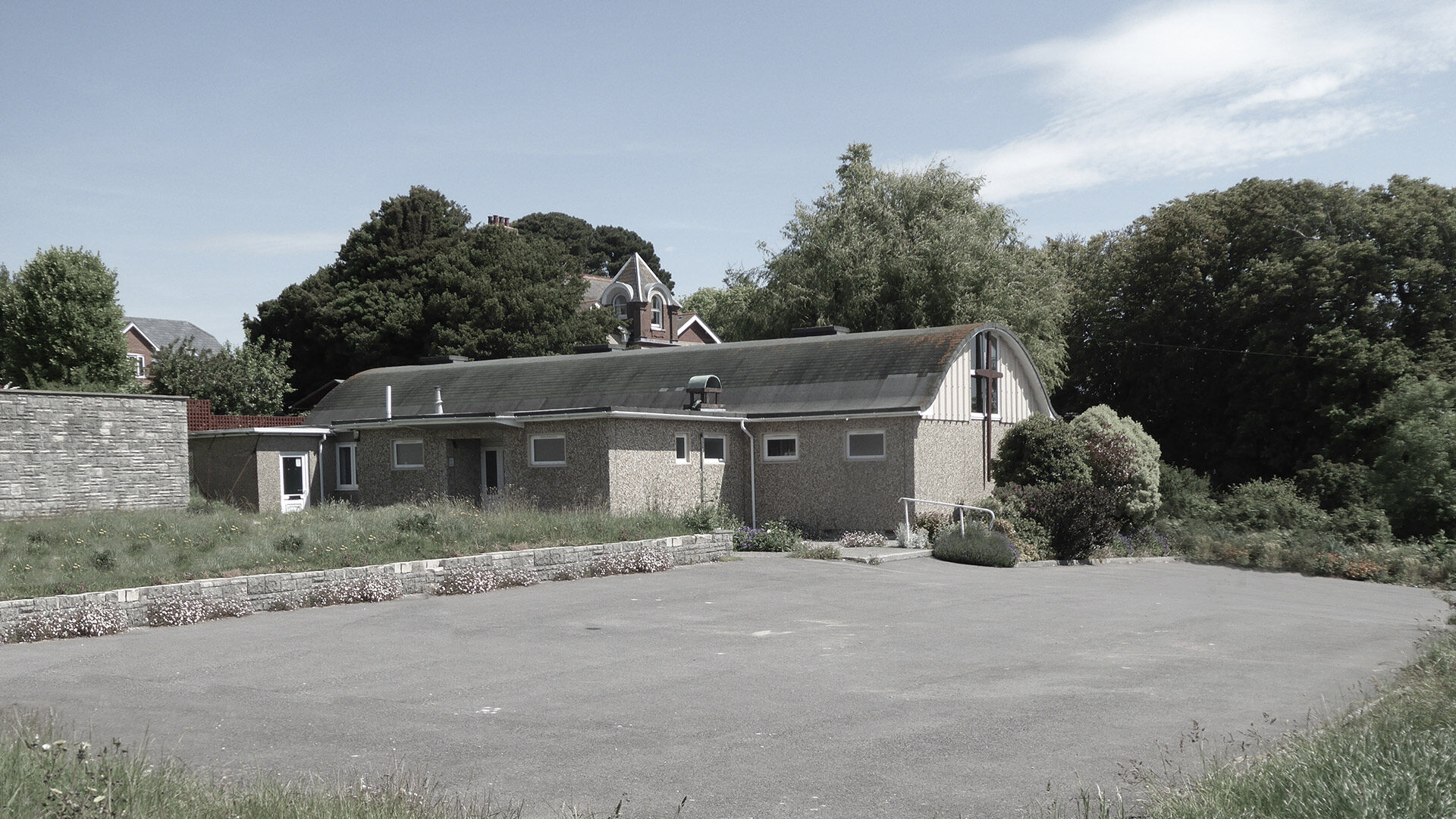 before photo of site with building and car park