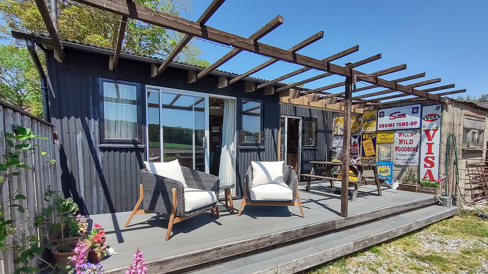 exterior rear view of converted barn with recycled materials and exposed beams