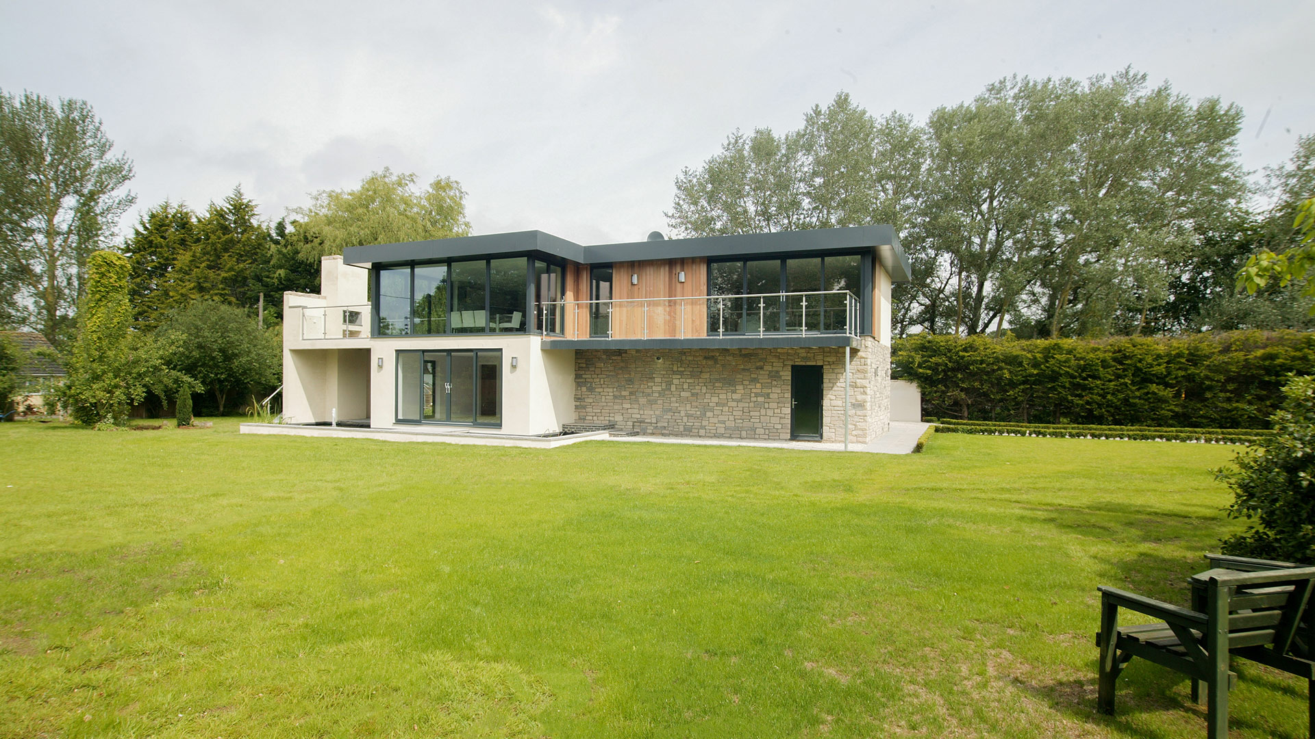 front view of beautiful modern house with stone and white wall and a flat roof