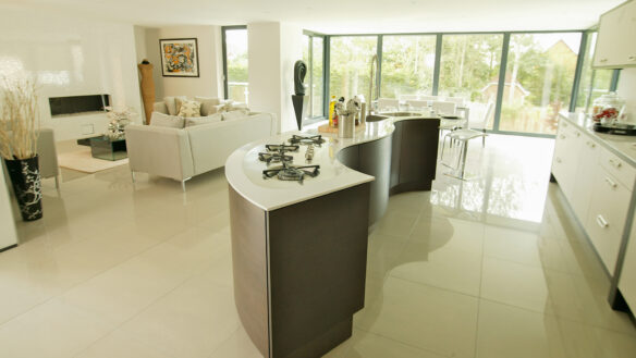 interior modern kitchen with curvy island with gas stoves and sink