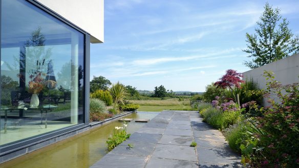 side view of house and view with large corner window and moat