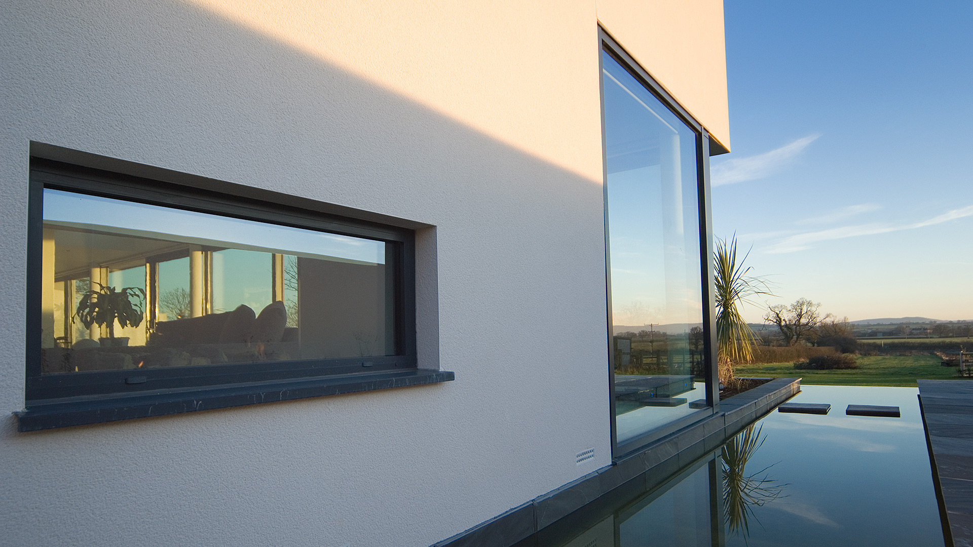 close up photo of modern house with moat around and stunning countryside views