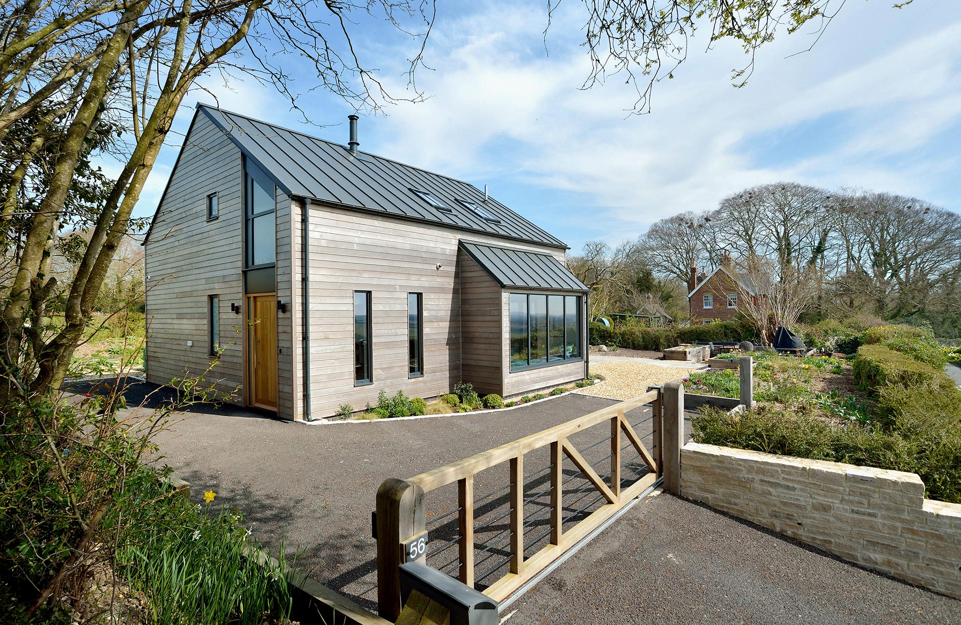 Modern rural house with timber cladding and metal roof view from entrance way