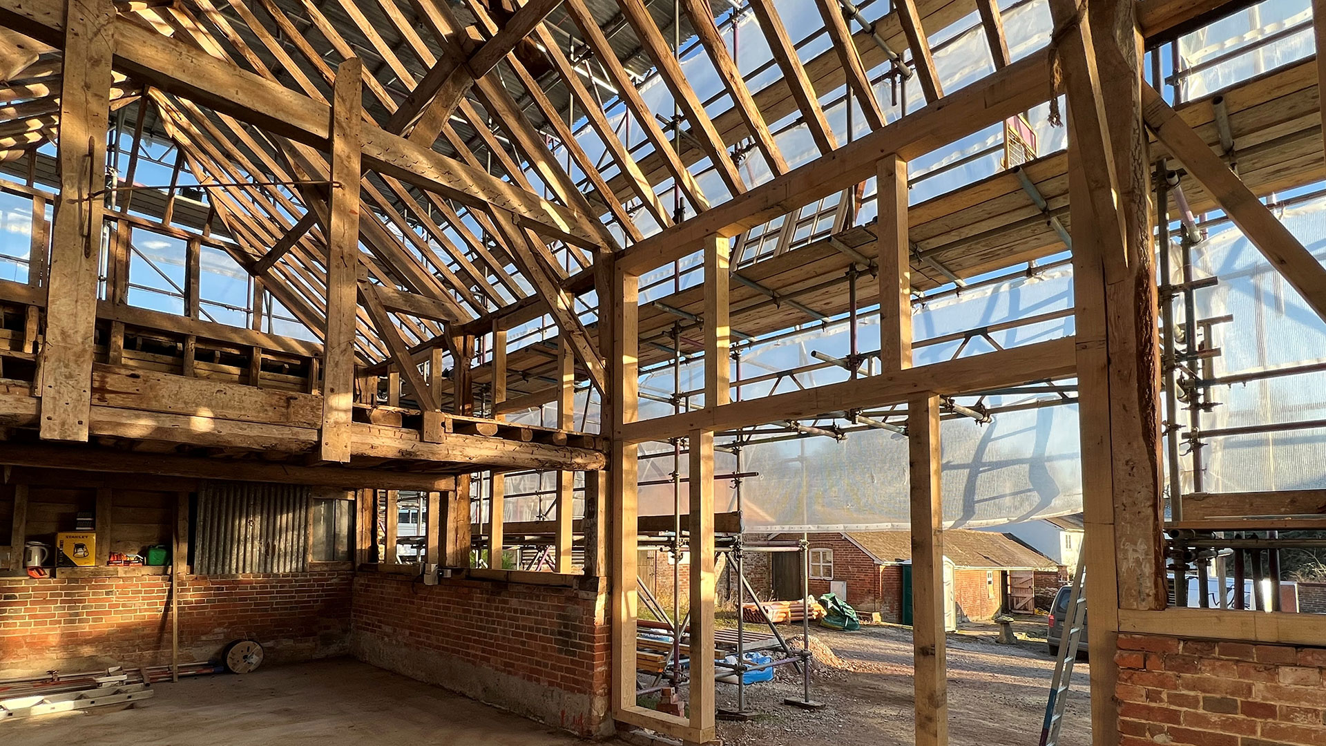 Barn conversion with exposed red bricks and wooden beams