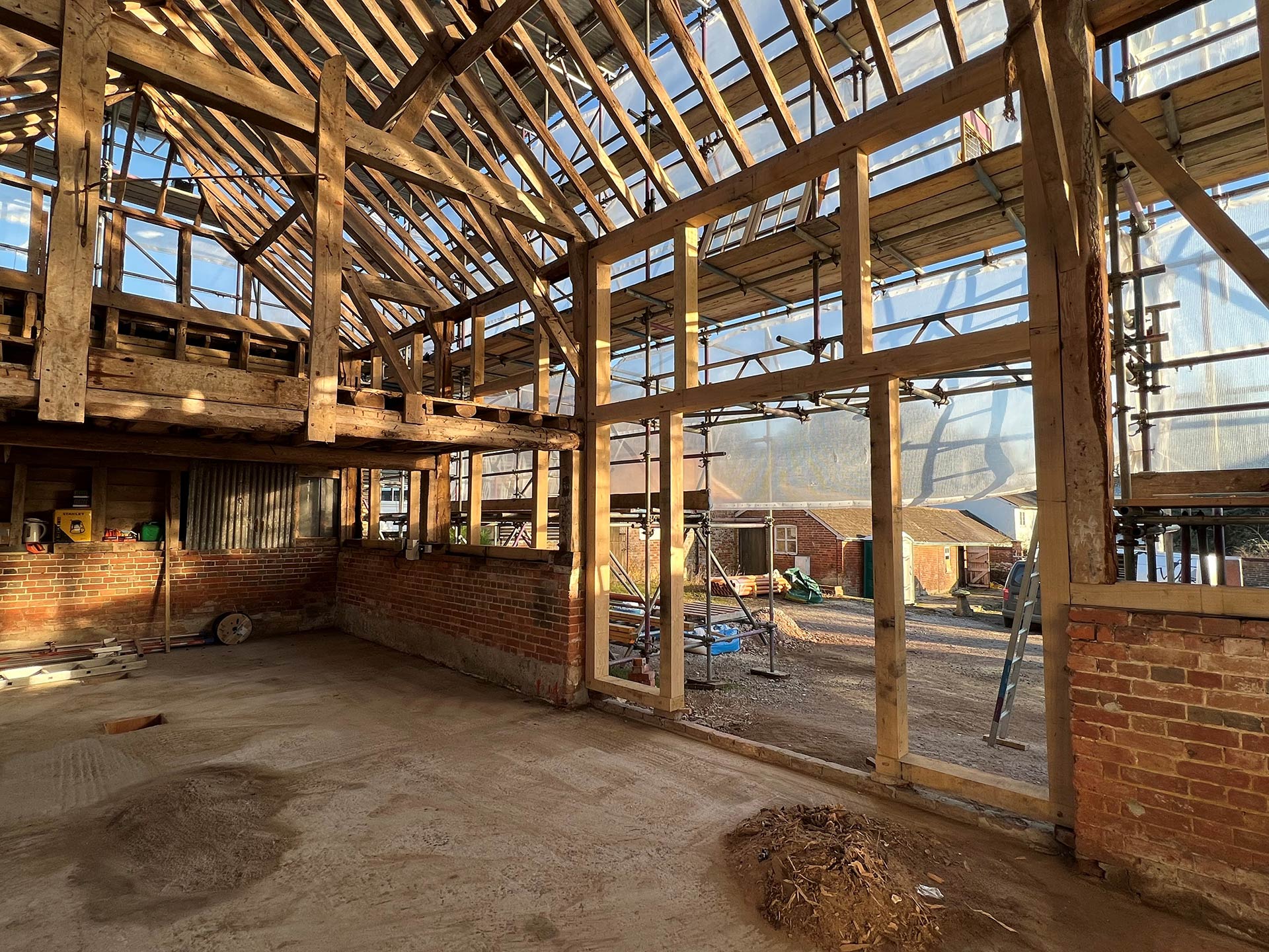 Barn conversion with exposed red bricks and wooden beams