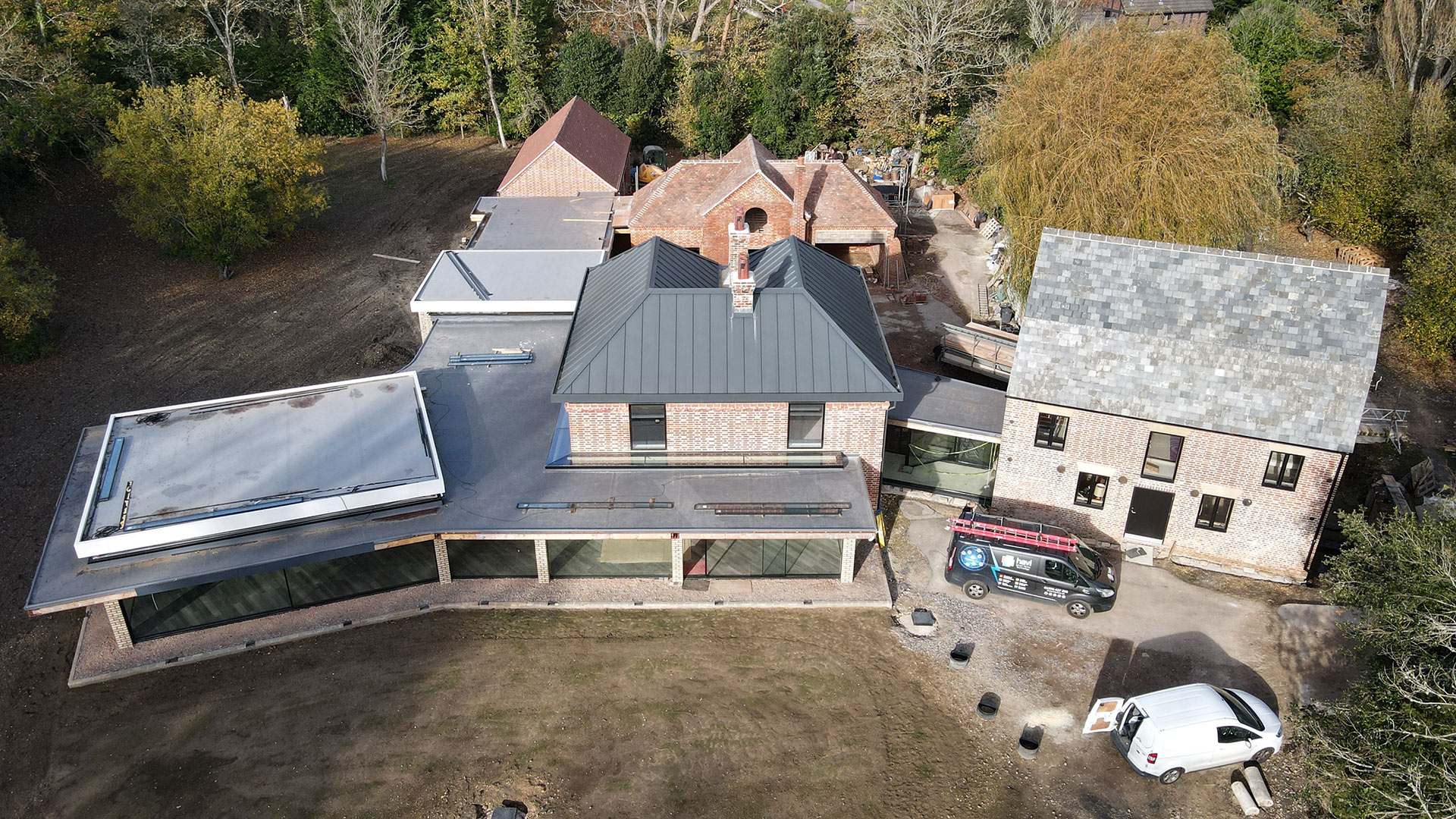 aerial view of house under construction with large glass windows