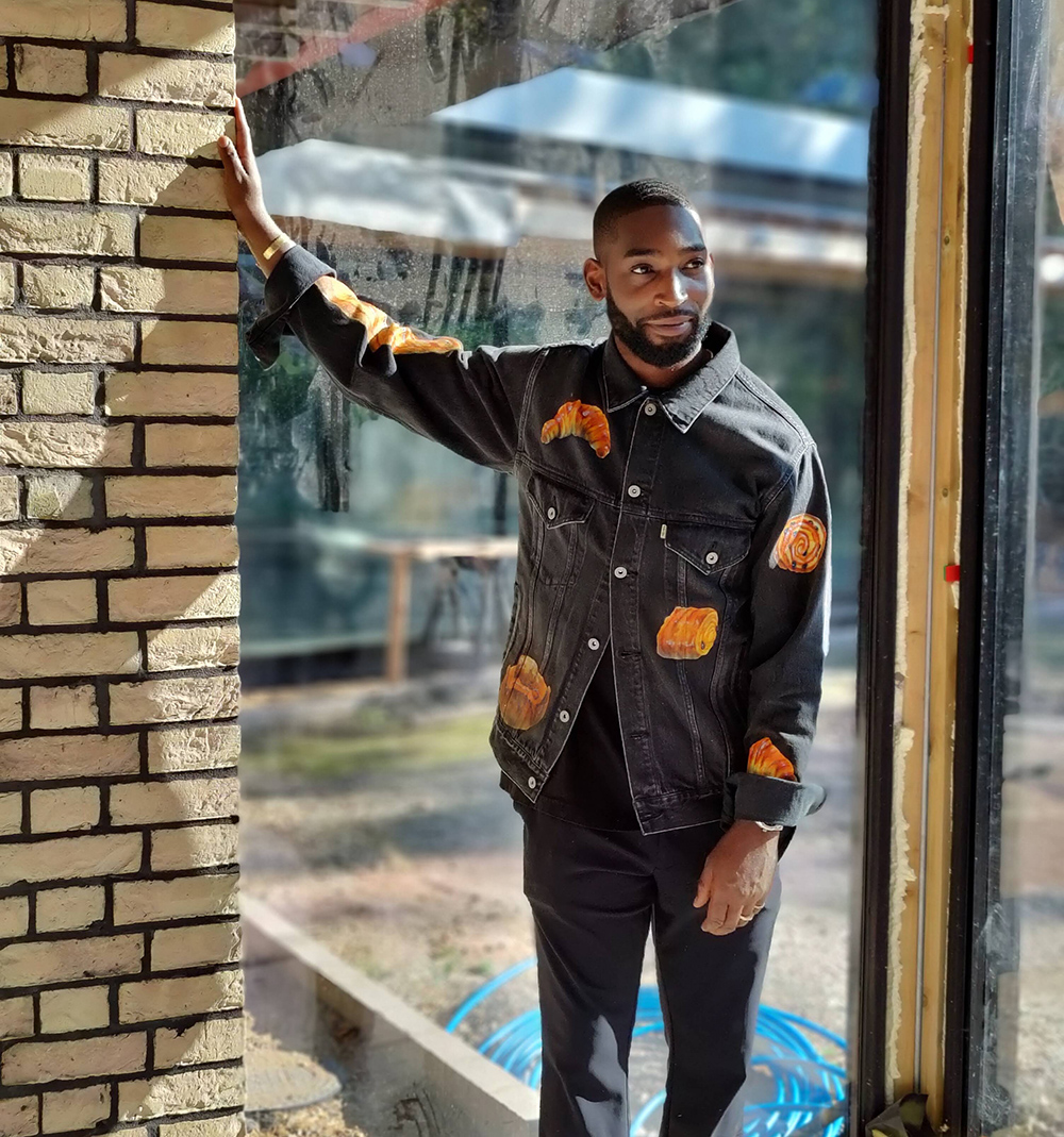 musician Tinie Tempah on site filming leaning hand against a wall