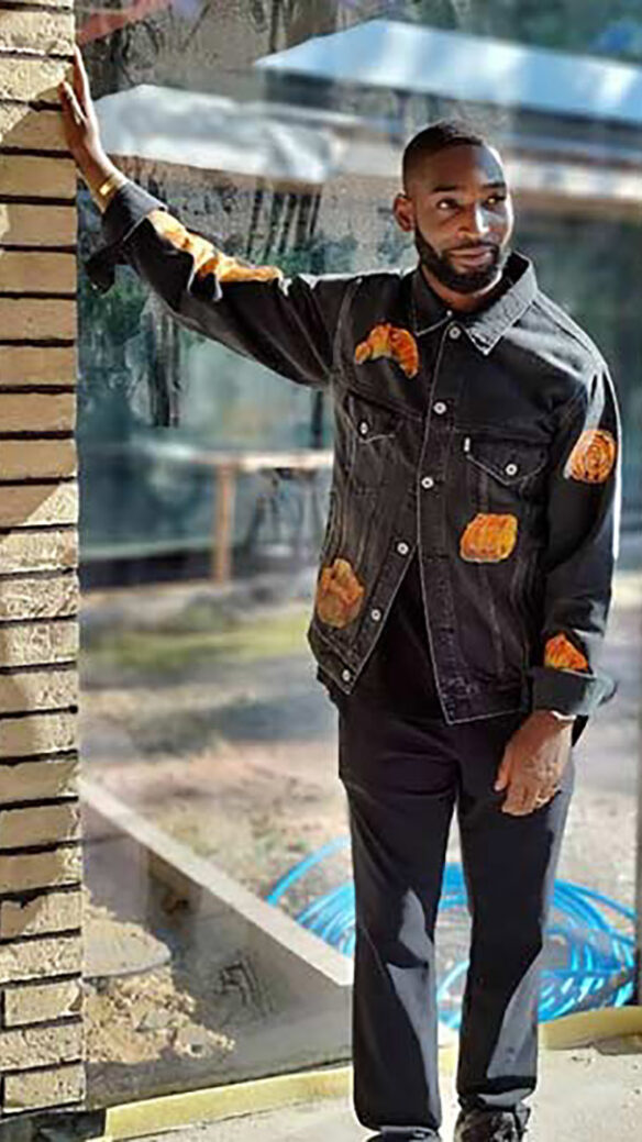 musician Tinie Tempah on site filming leaning hand against a wall