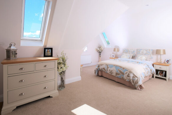 bedroom interior in white and neutral tones with roof windows