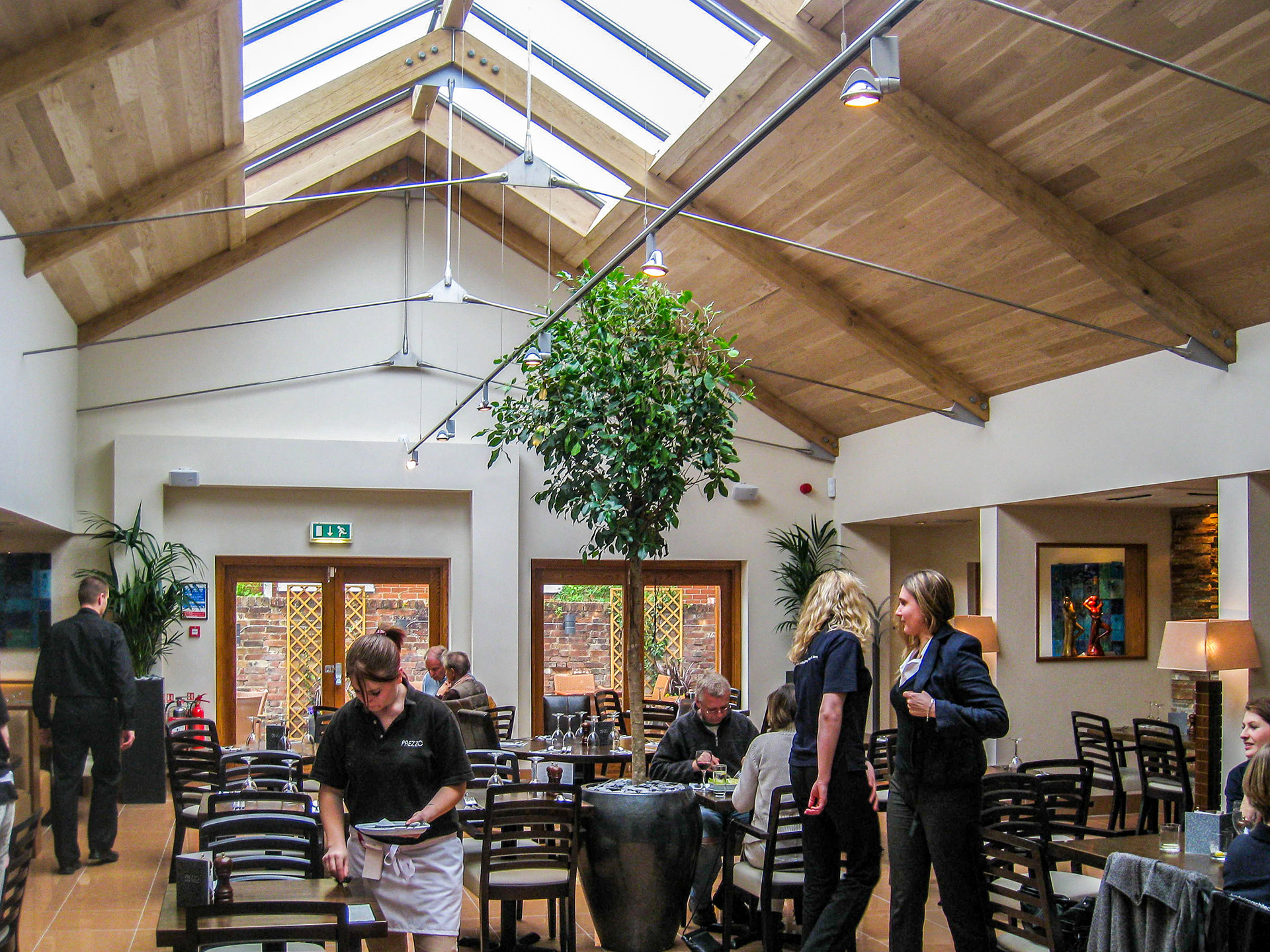 interior of restaurant with large dining area and vaulted ceilings