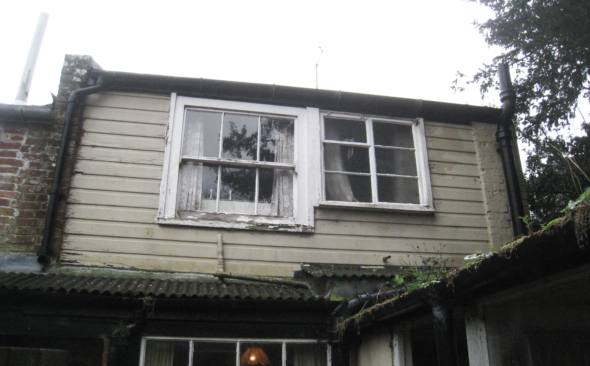 before photo of house with rotting timber windows