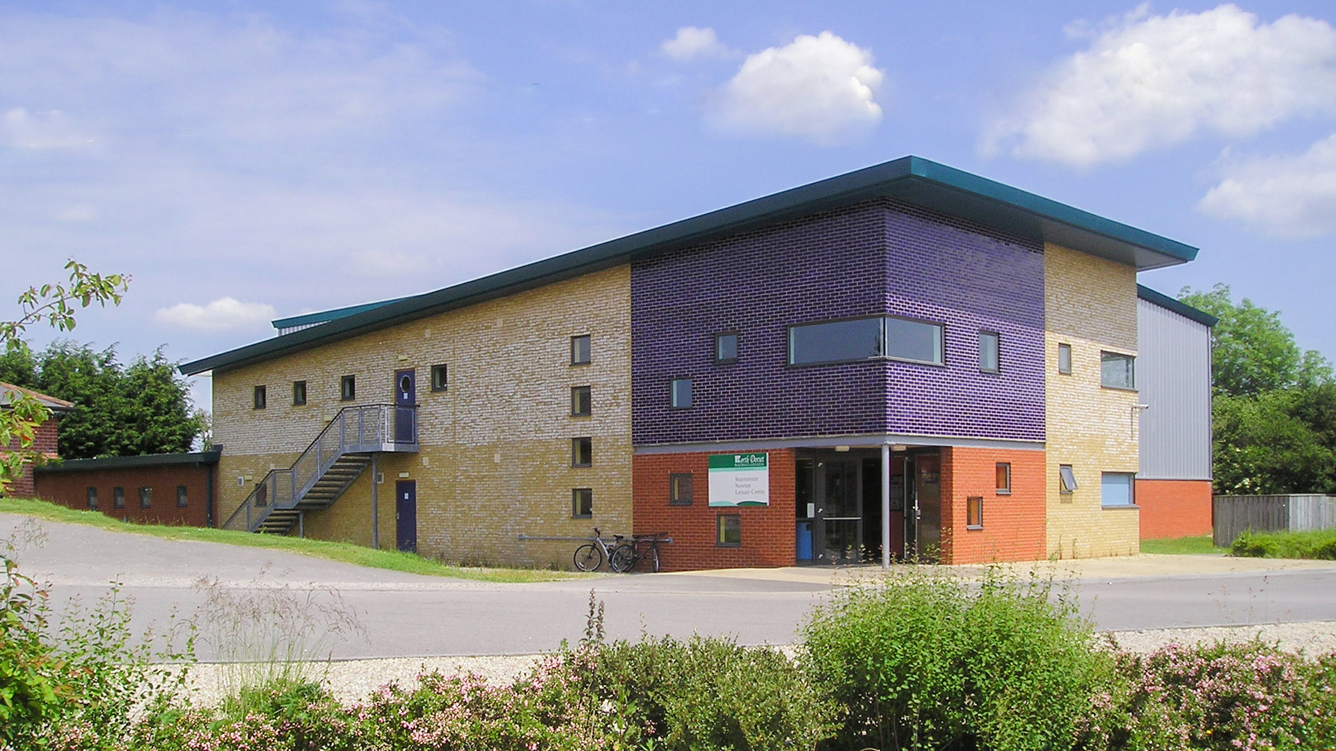 front and side view of sports centre taken from across road