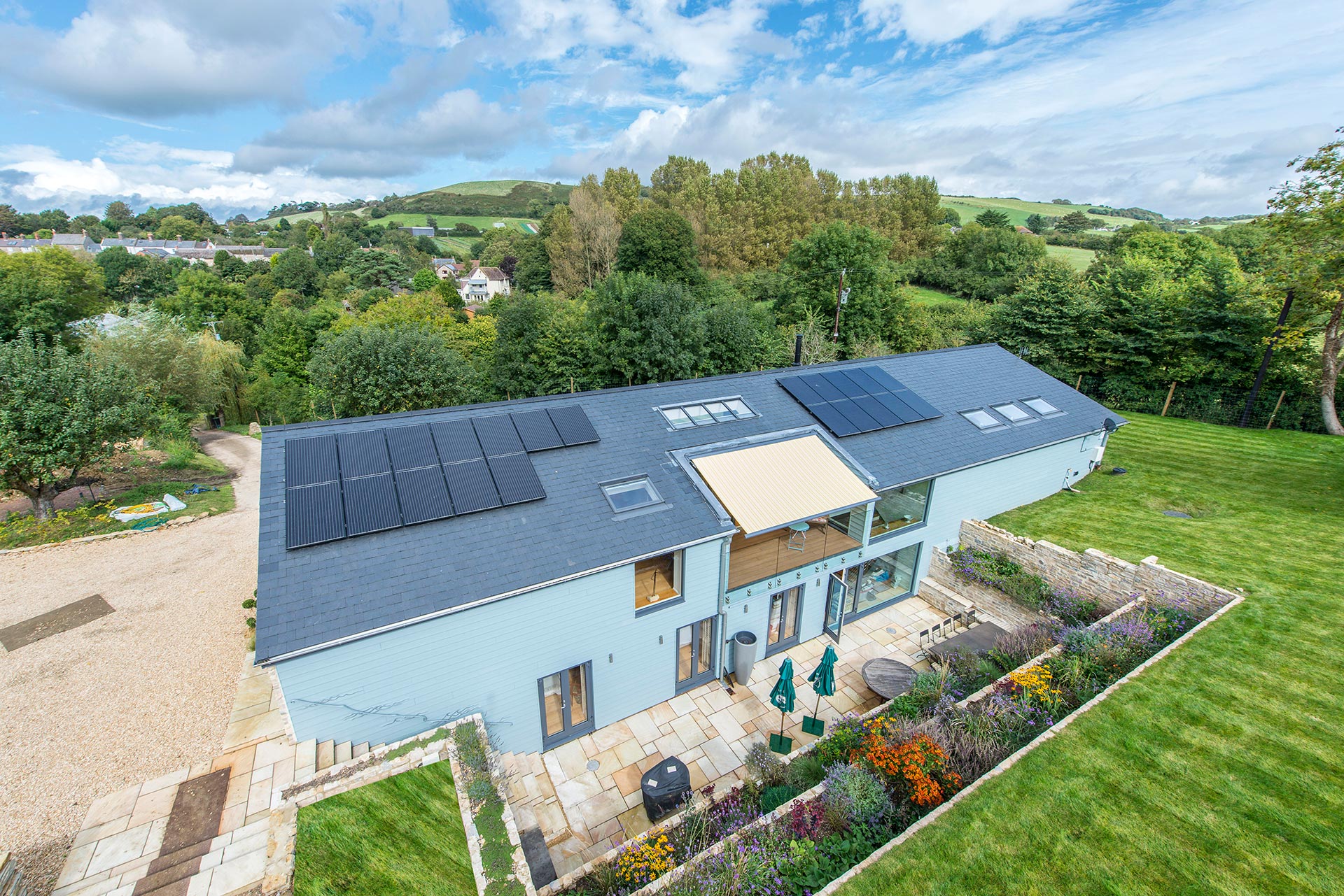 aerial view of single storey house above ground with an extensive sunken terrace and subterranean level