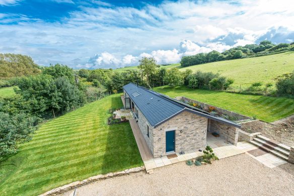 aerial view of single storey house above ground with an extensive sunken terrace and subterranean level