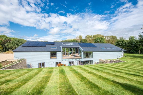 rear garden view of single storey house above ground with an extensive sunken terrace and subterranean level