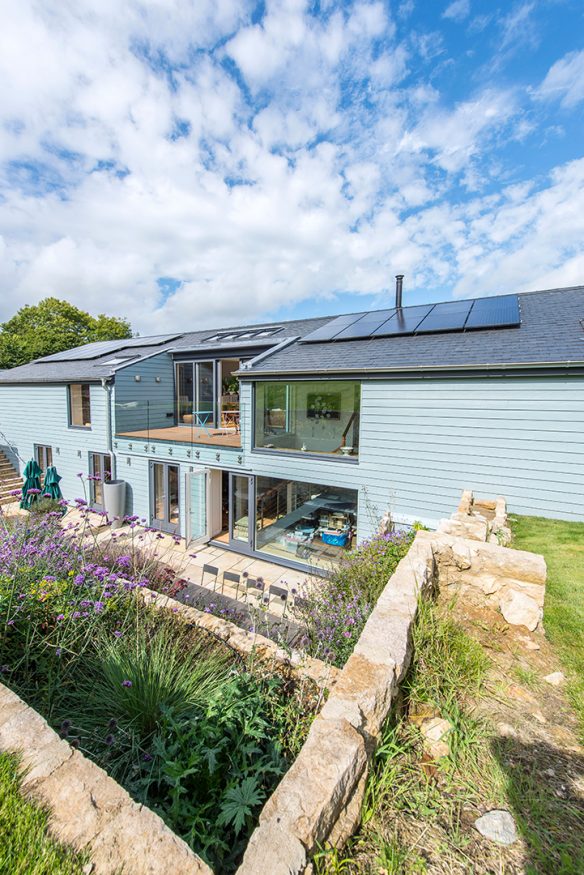 rear garden view of single storey house above ground with an extensive sunken terrace and subterranean level