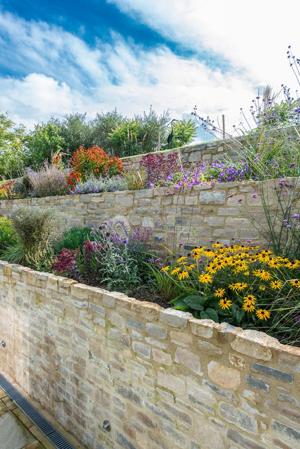 sunken terrace with stone brickwork and beautiful flowers