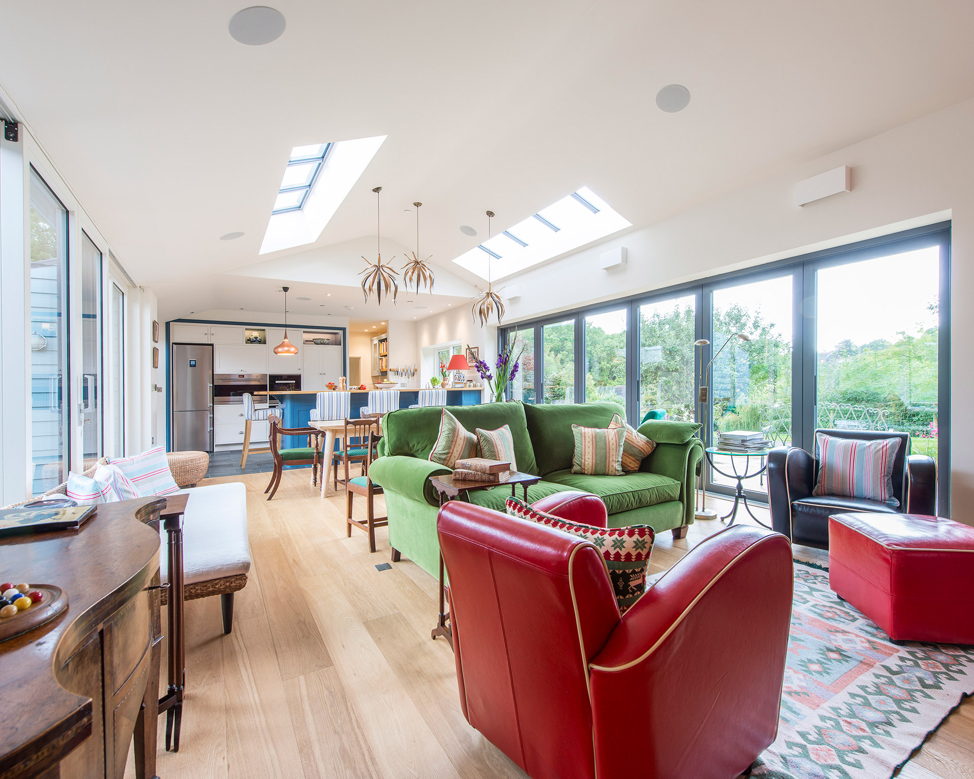 open plan dining living room with vaulted ceilings and featured ceiling light fittings