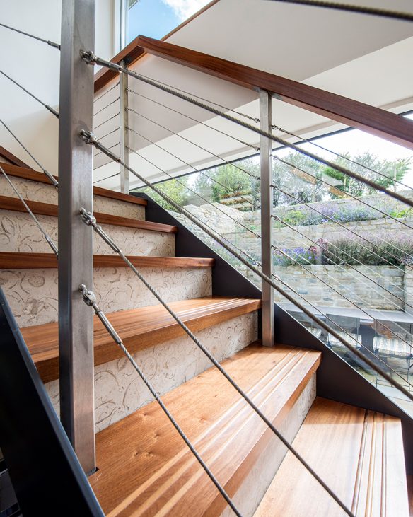 detailed photo of wooded staircase with wire balustrade