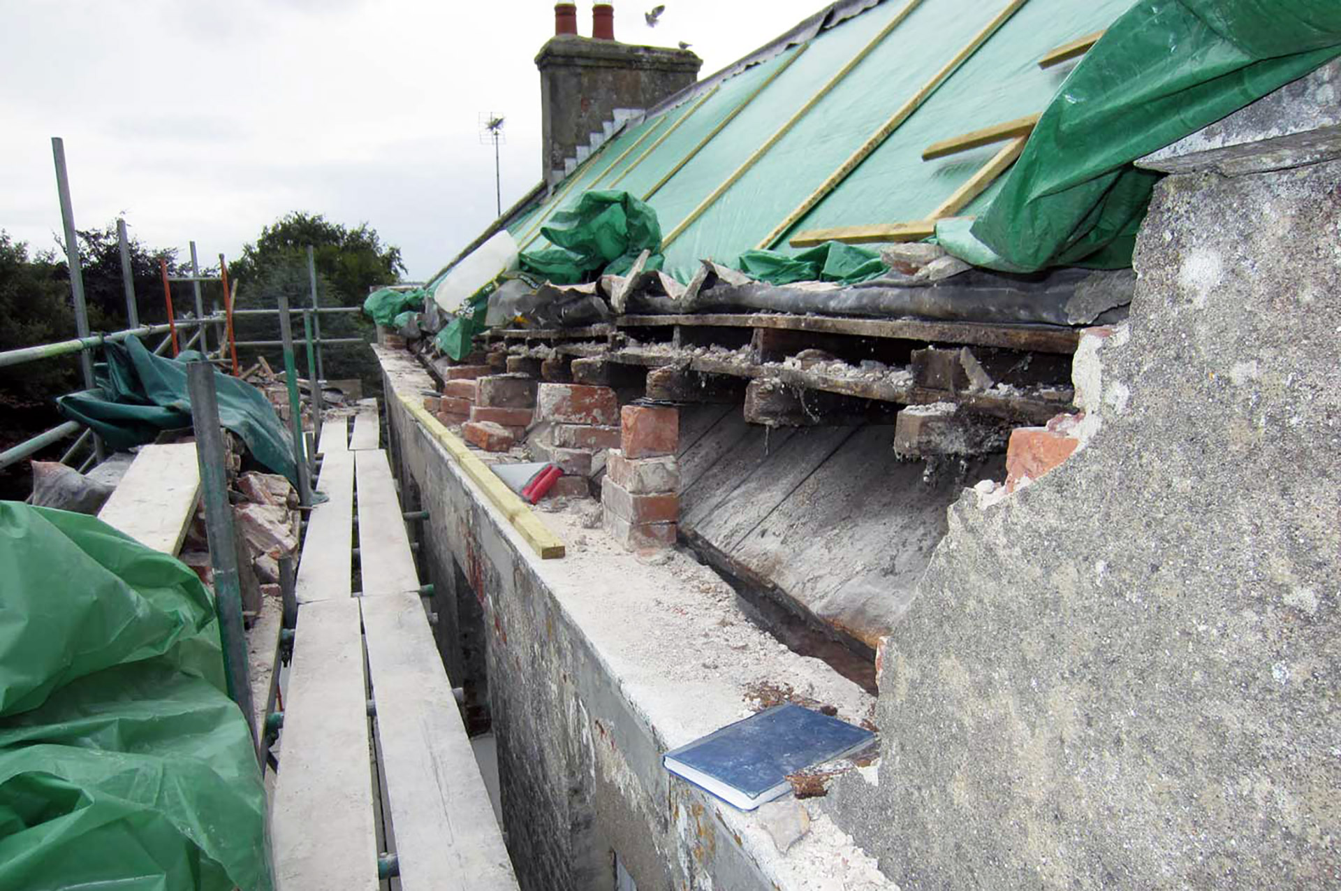 before photo of roof work under construction with scaffolding around