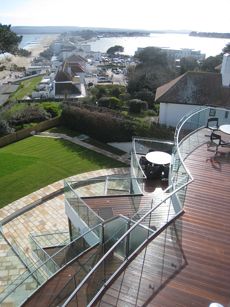 aerial view of balconies in petal design and lawn in garden with sea views