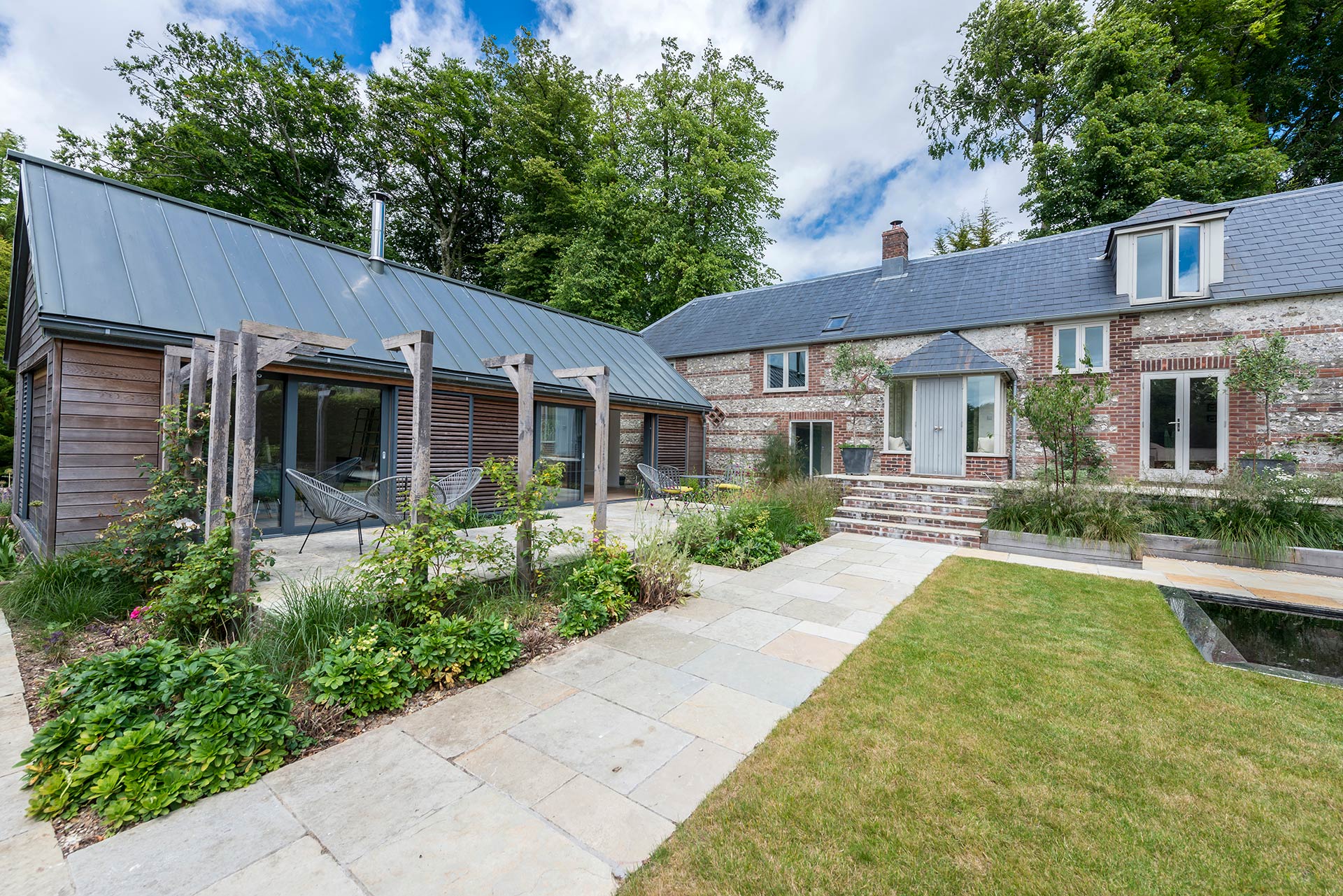 garden view of traditional large cottage with modern extension