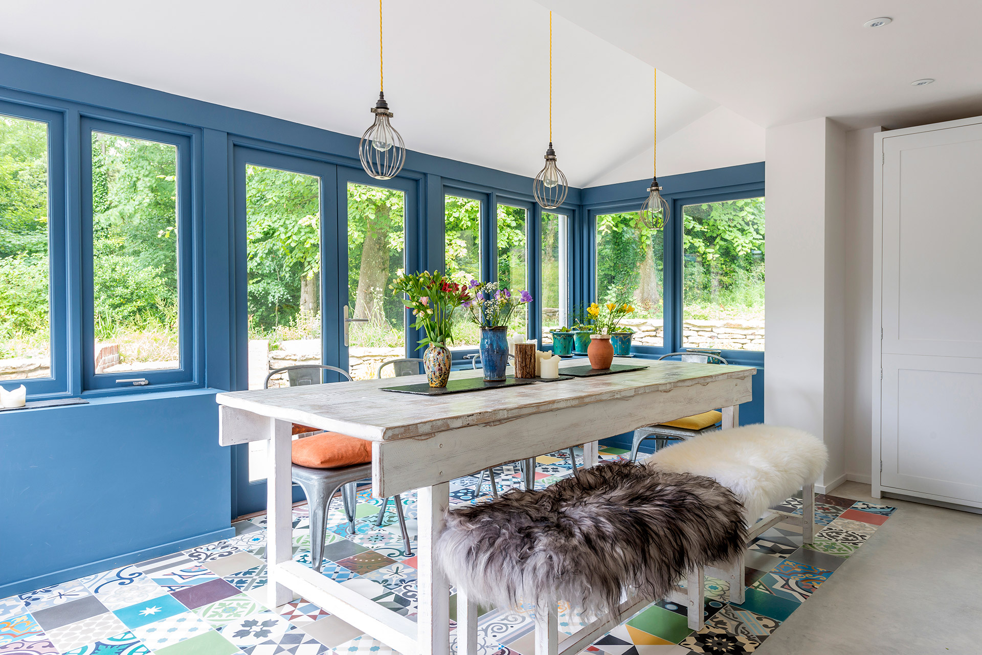 interior dining area with colourful floor tiles and blue walls