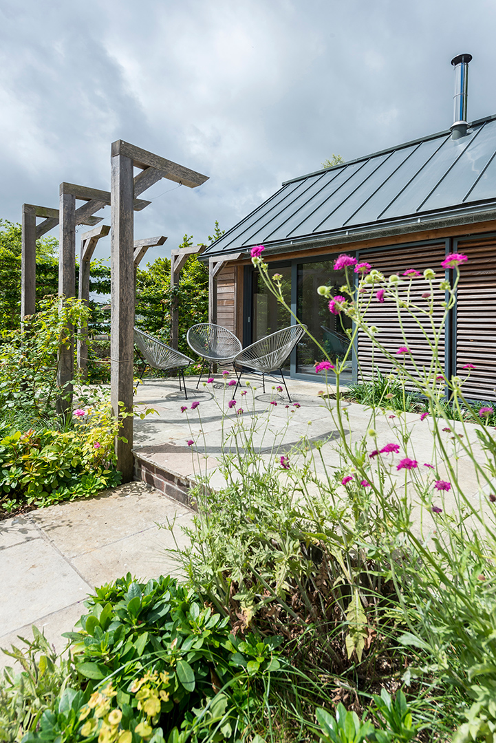 side view of extension with timber cladding and sliding doors leading to patio area